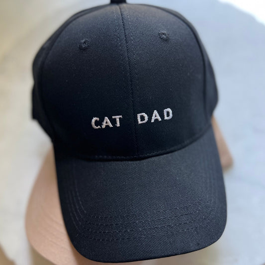 black baseball cap with cat dad embroidered in white
